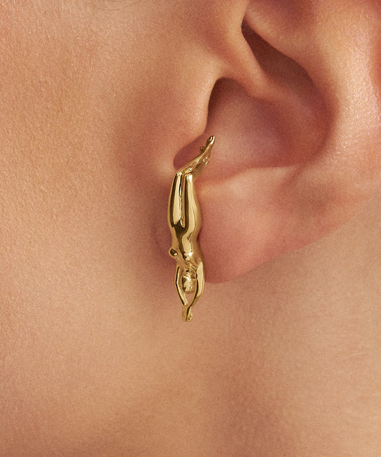 Modelo com brinco em prata 925 com banho de ouro 18k de corpo de mulher