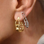 Modelo usando brincos de prata 925 com banho de ouro 18k argola e alfinete com corpos femininos